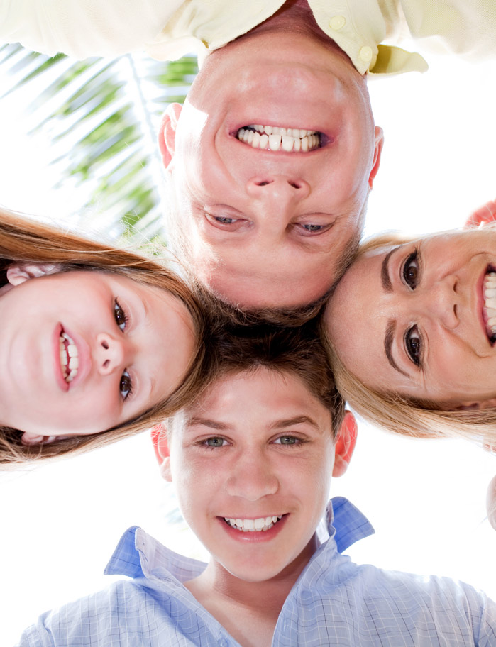 happy family smiling and joining their heads together